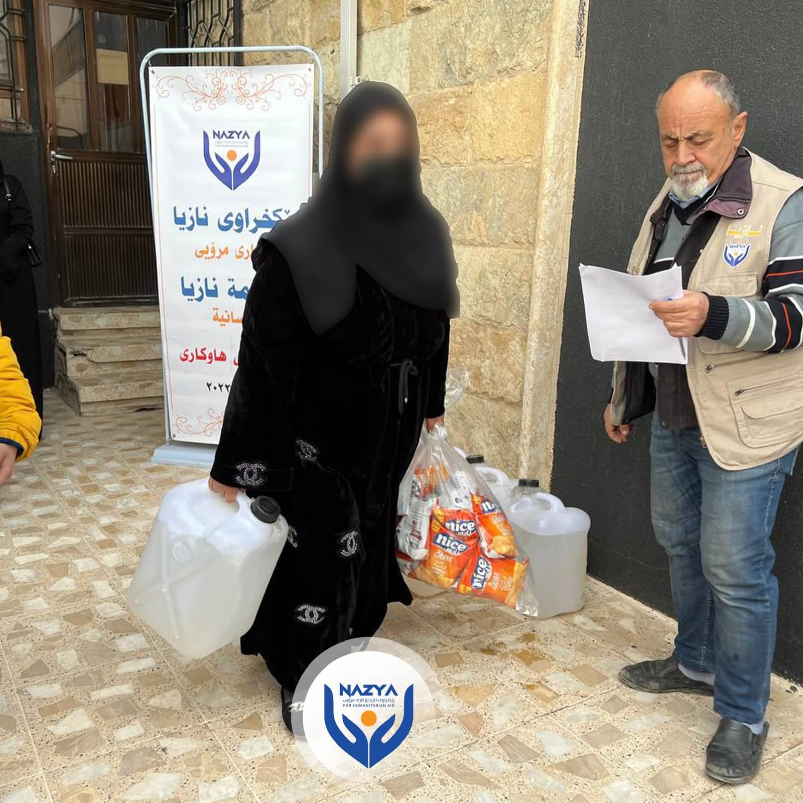 Nazya Humanitarian Aid distributing heating oil (kerosene) to families for heaters (zopa) during winter in Kurdistan